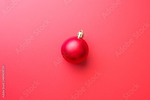 Christmas ball bauble on red background top view