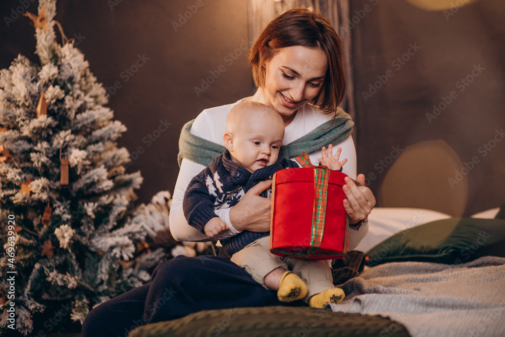 Mother with her baby boy celebrating christmas Mother with her baby boy celebrating christmas