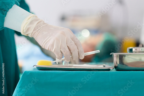 Selective focus at hand, doctor holds a syringe in his hand, hand holding syringe prepare for injection in operating room