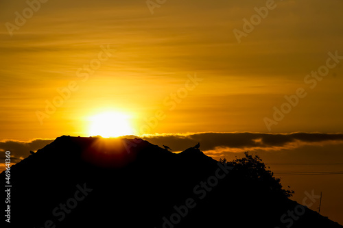 Sunrise and silhouette of house roof on  sky background in the morning