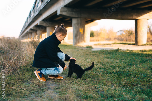 Boy and cat under the bridge