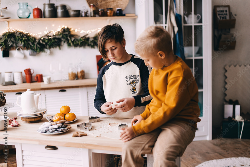 two boys are cooking christmas cookies two boys are cooking christmas cookies