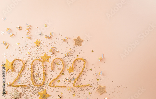 Happy new year celebration background concept made from golden christmas ball and star on pastel background.