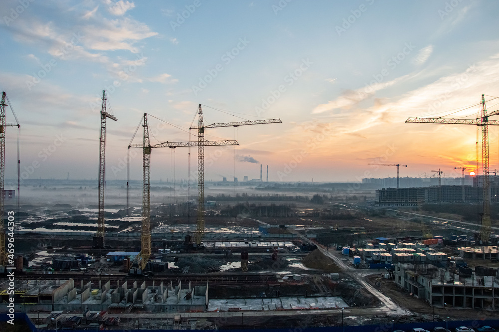 Construction cranes on the background of the sunset. Construction cranes on the background of the sunset.