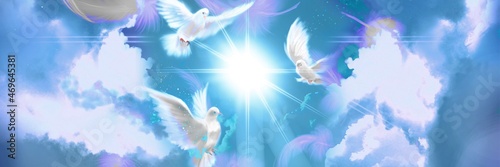 The flying three white doves around clouds leading to shining heaven and the background of beautiful pastel color’s sky and fluffy feathers	