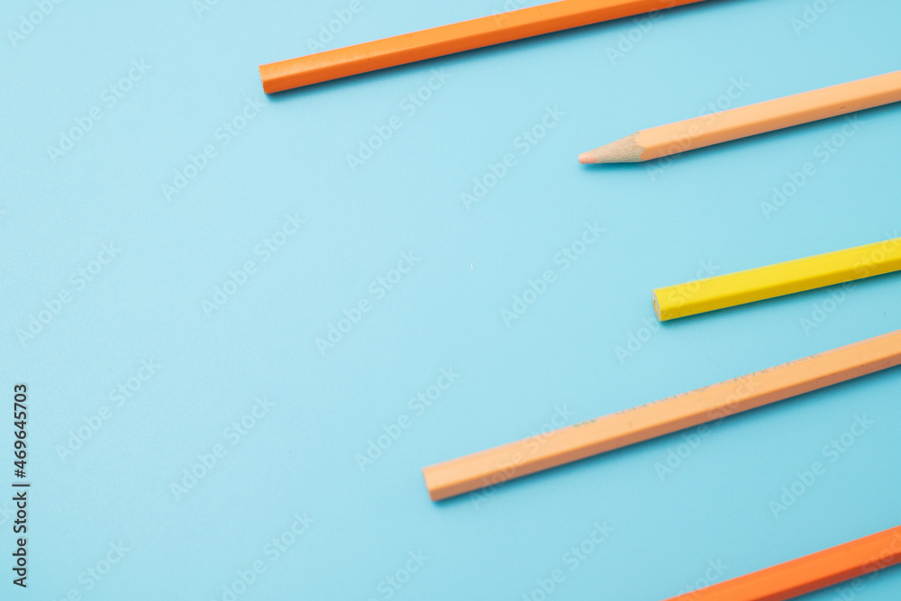 educational direction concept colored pencils on a blue background