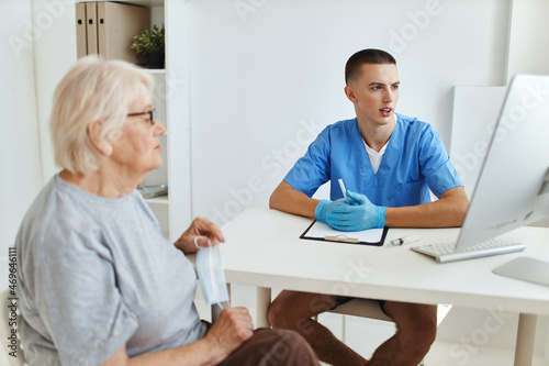 elderly woman patient talking to doctor hospital visit