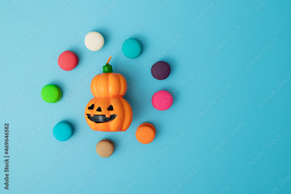 Fototapeta premium halloween concept pumpkin jack o lantern with colorful candy on blue background 