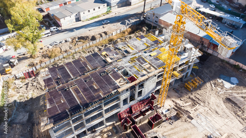 Construction site background. Hoisting cranes and new multi-storey buildings. Industrial background