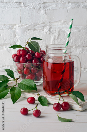 Ripe cherries and cherry juice in the mason jar