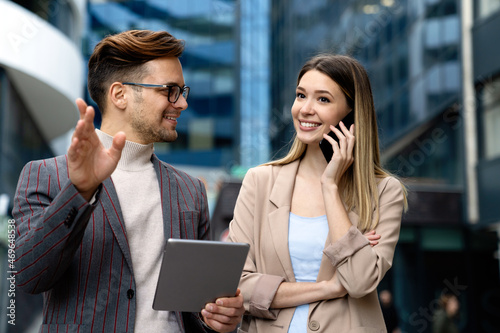 Two desingers, business people working on a project together in urban background