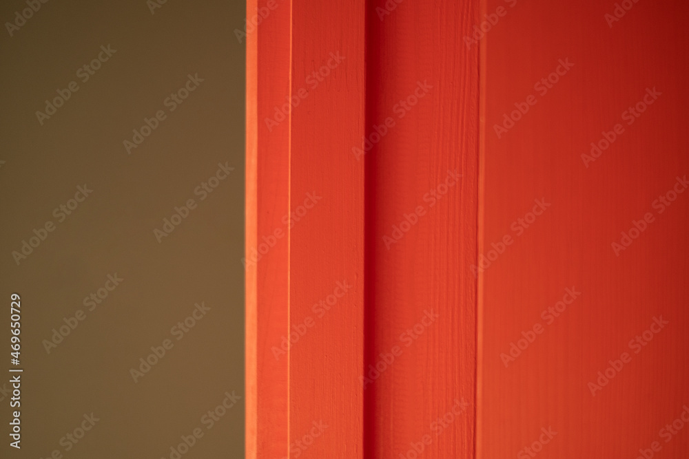 Part of a wooden board or door painted red close-up on a nice brown background. High quality photo