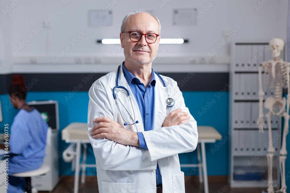 Portrait of smiling medic with white coat and stethoscope standing with arms crossed. Healthcare specialist being ready for consultation and examination with patient, giving medical advice. Portrait of smiling medic with white coat and stethoscope standing with arms crossed. Healthcare specialist being ready for consultation and examination with patient, giving medical advice.