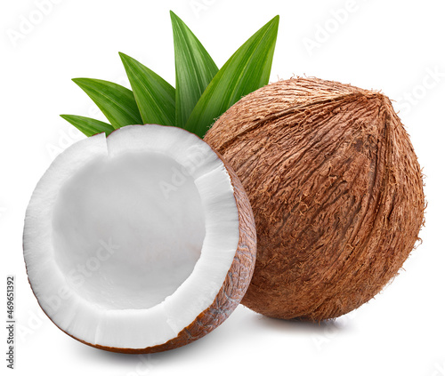 Ripe whole coconut with green leaf and half