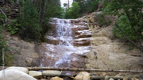 Small rocky cliff waterfall in San Juan National Forest, static view photo