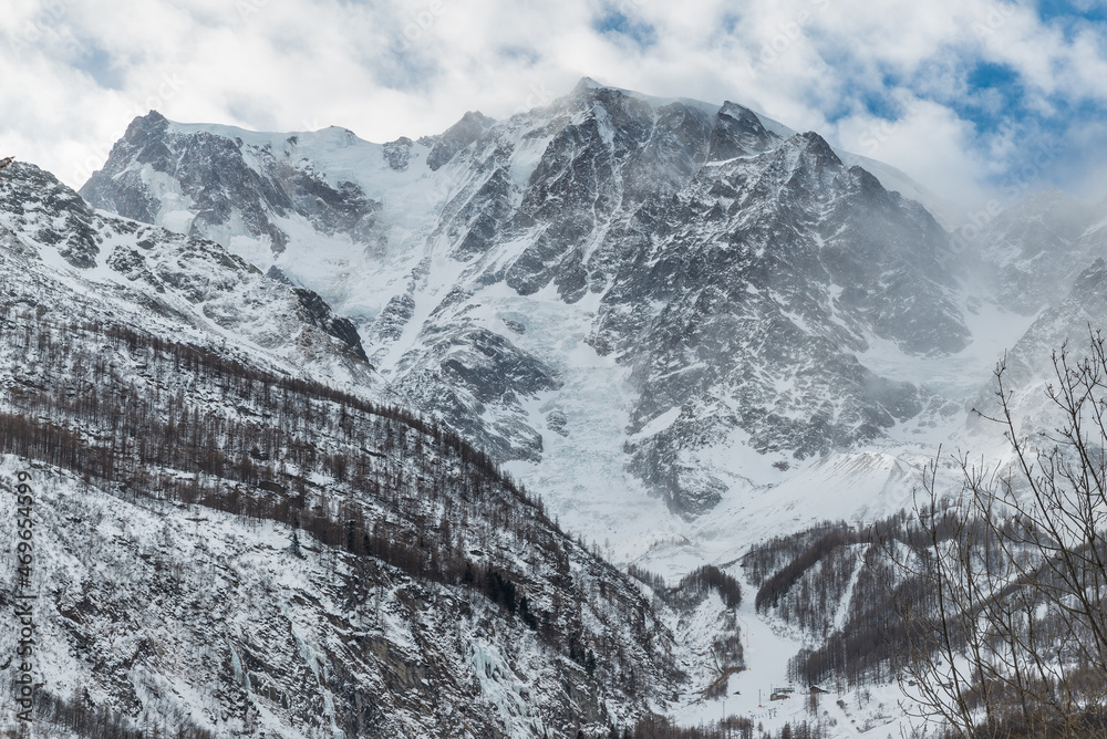 Obraz premium European Alps in winter. Monte Rosa from Macugnaga, north Italy, with the impressive east wall covered with ice and, at the base, one of the two ski areas. Winter background 
