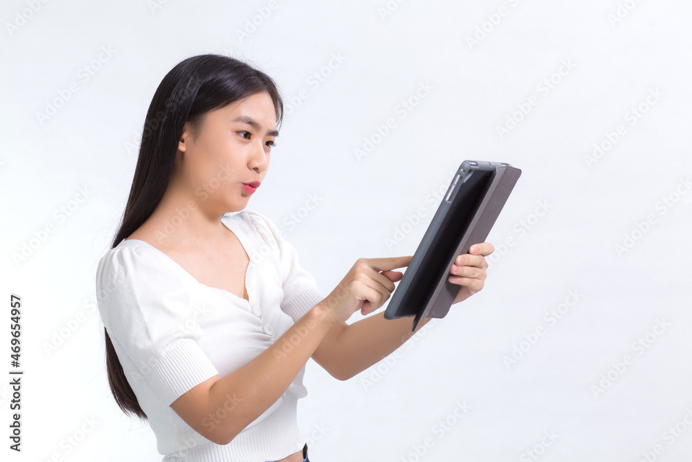Image of beautiful young Asian college students Are using a tablet phone with pleasure On a white background. Image of beautiful young Asian college students Are using a tablet phone with pleasure On a white background.