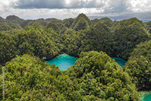 Tropical sea bay and lagoon, beach in Bucas Grande Island, Sohoton Cove. Philippines. Tropical landscape hill, clouds and mountains rocks with rainforest. Azure water of lagoon. photo