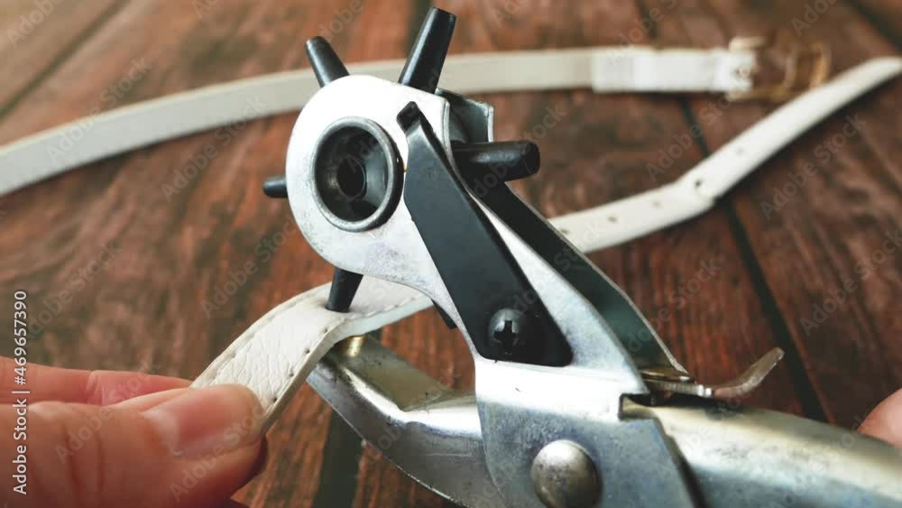 The process of manufacturing a leather belt by tanner. Puncture holes