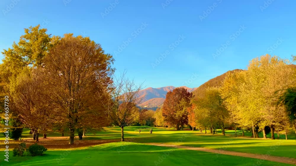 Golf Course Hole 8 in Autumn with Mountain View in a Sunny Day in Lugano, Switzerland. Golf Course Hole 8 in Autumn with Mountain View in a Sunny Day in Lugano, Switzerland.