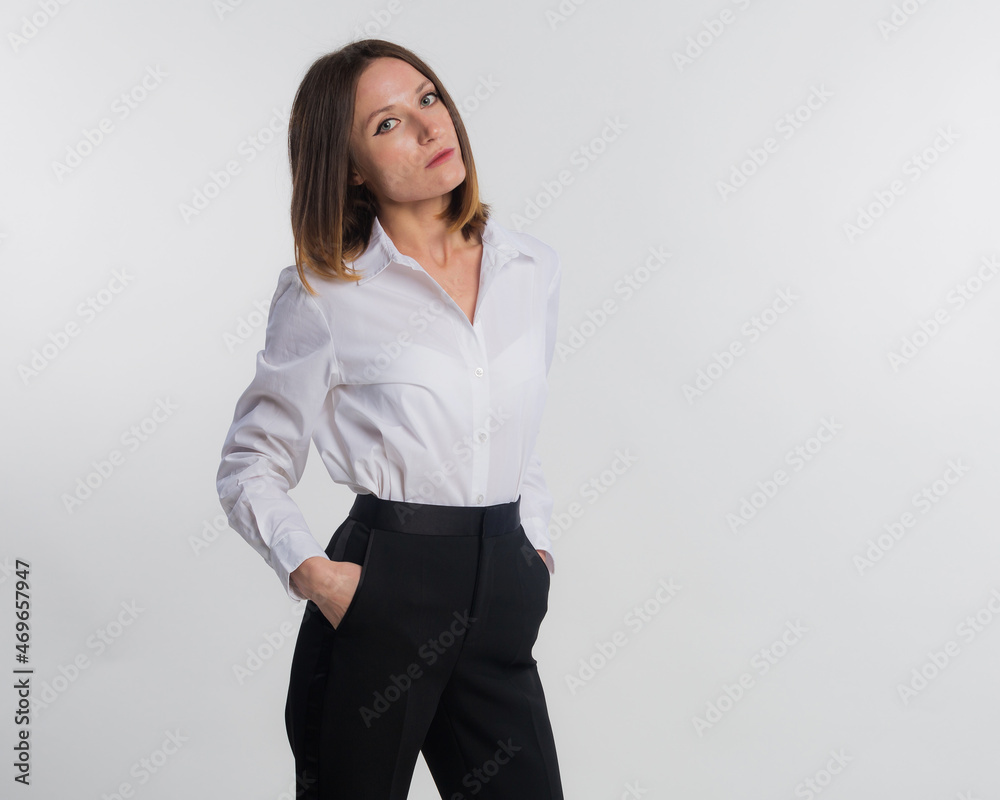 Portrait of elegantly young blond hair woman dressed in white shirt. Business woman smiling, successful looking at camera isolated on gray background. Studio shot, copy space Portrait of elegantly young blond hair woman dressed in white shirt. Business woman smiling, successful looking at camera isolated on gray background. Studio shot, copy space