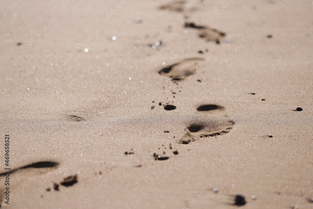 Human foot prints on golden beach sand Human foot prints on golden beach sand