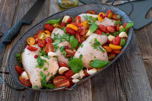 Italian chicken legs with vegetables in a pan