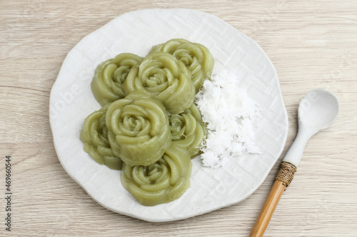 Kue Lumpang Pandan or Kue IJo, Indonesian traditional food with springy texture, made from sago flour and rice flour, sugar and pandan. Served in white plate, selective focus image.
 photo