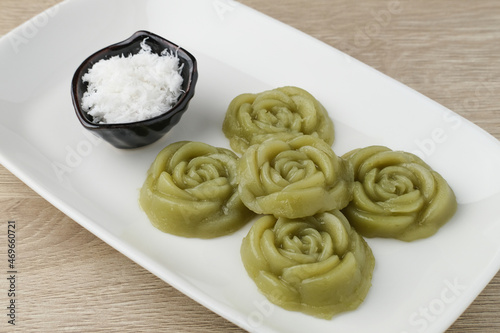 Kue Lumpang Pandan or Kue IJo, Indonesian traditional food with springy texture, made from sago flour and rice flour, sugar and pandan. Served in white plate, selective focus image.
 photo