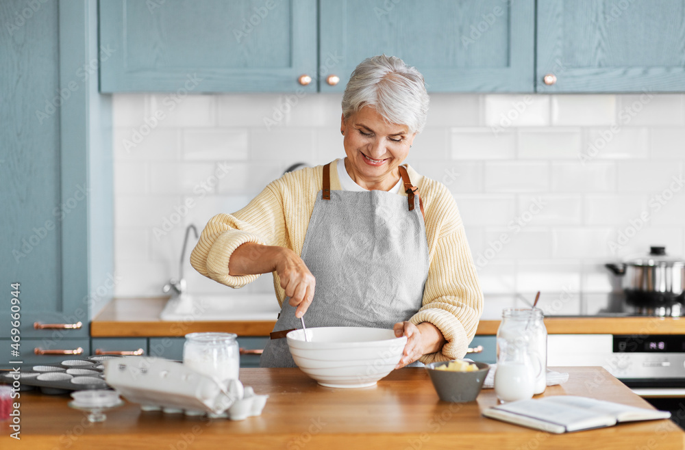 people and culinary concept - happy smiling woman cooking food on kitchen at home people and culinary concept - happy smiling woman cooking food on kitchen at home