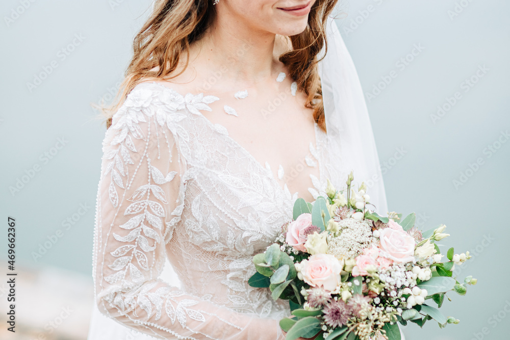 Beautiful bride is holding a bridal bouquet with eucalyptus and roses. Modern wedding. Bridal bouquet Beautiful bride is holding a bridal bouquet with eucalyptus and roses. Modern wedding. Bridal bouquet