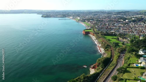 Aerial view of train going along Torquay seafront on a sunny day