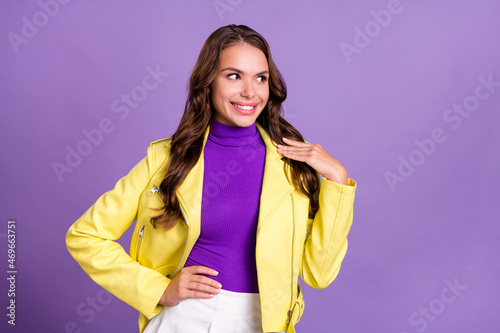Photo of young cheerful woman wondered minded look empty space isolated over violet color background