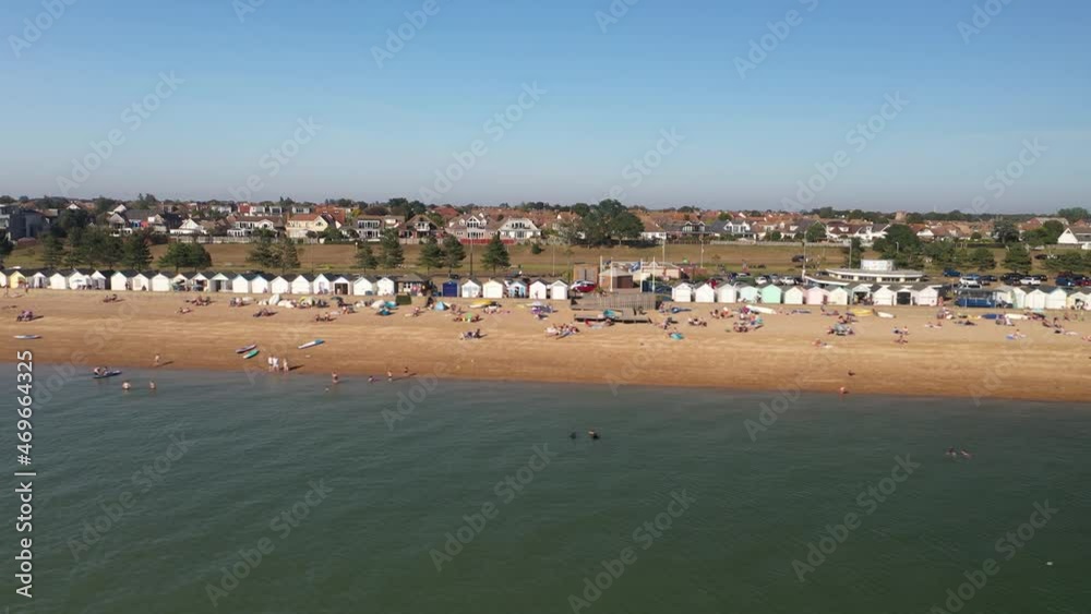people enjoying sunny day on sandy beach. Urban neighbourhood in background. Southend-on-Sea, UK people enjoying sunny day on sandy beach. Urban neighbourhood in background. Southend-on-Sea, UK