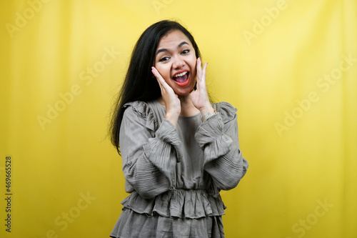 Beautiful young woman surprised, shocked, wow expression, presenting something, promoting a product, advertising, isolated
