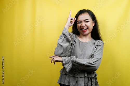 Beautiful young woman, pointing up, getting ideas isolated