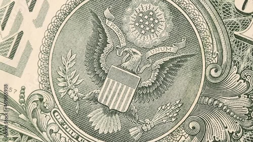 Great seal on 1 US dollar bill slow rotating, bald eagle.