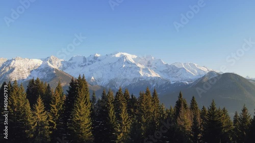 Mont Blanc mountain in Chamonix, France with fir and spruce tree in foreground. Scenic alpine mountain landscape. 4k 60 fps video footage.