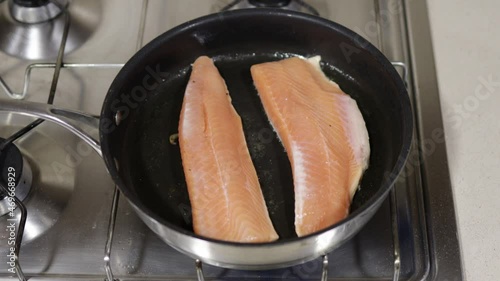 Frying pan with two salmon fillet