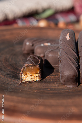 Chocolate with caramel and nuts. Copy space. Close-up. Soft focus background.