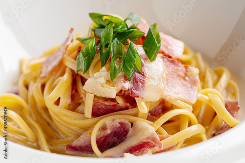 Cooked italian carbonara spaghetti pasta garnish with bacon photo