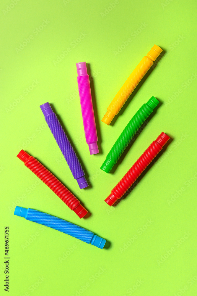 Bright new straight pop tubes on green paper background