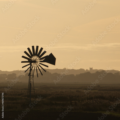 Windmill in orange morning sunrise.