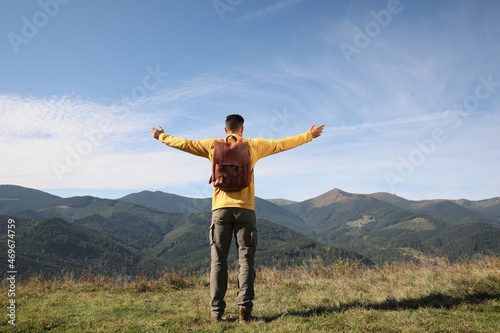 Man enjoying beautiful mountain landscape, back view