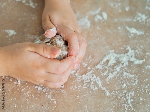 kid hands making cookie dough. Kneading dough. Cooking and baking. Background with place for text