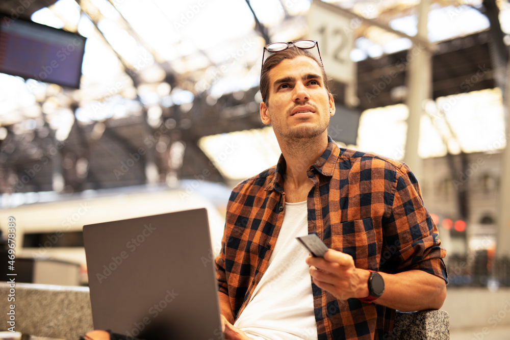 Man shopping online with laptop. Young man buying online with credit card. Man shopping online with laptop. Young man buying online with credit card.