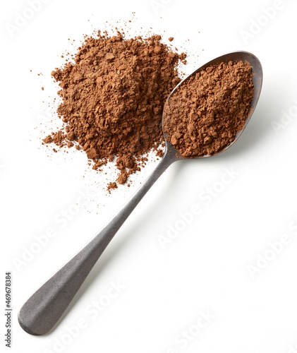 Heap and spoon of cocoa powder