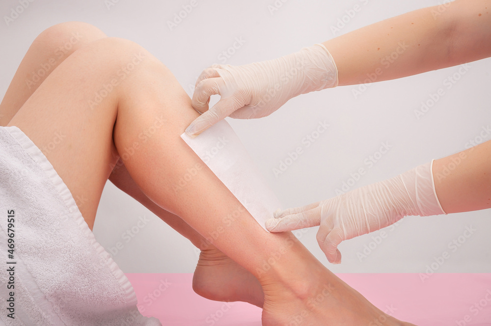 Fototapeta premium Spa professional doing waxing. Woman waxing her legs