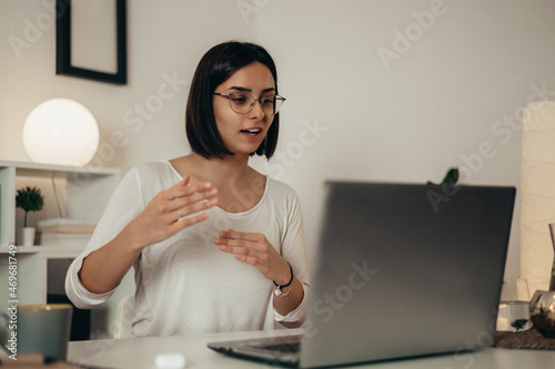 Woman using a laptop for an online meeting while working from home