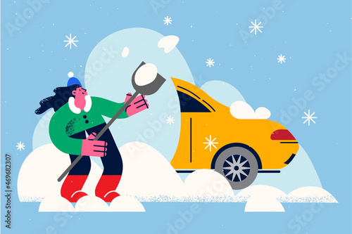 Woman dig out car from snow pile 